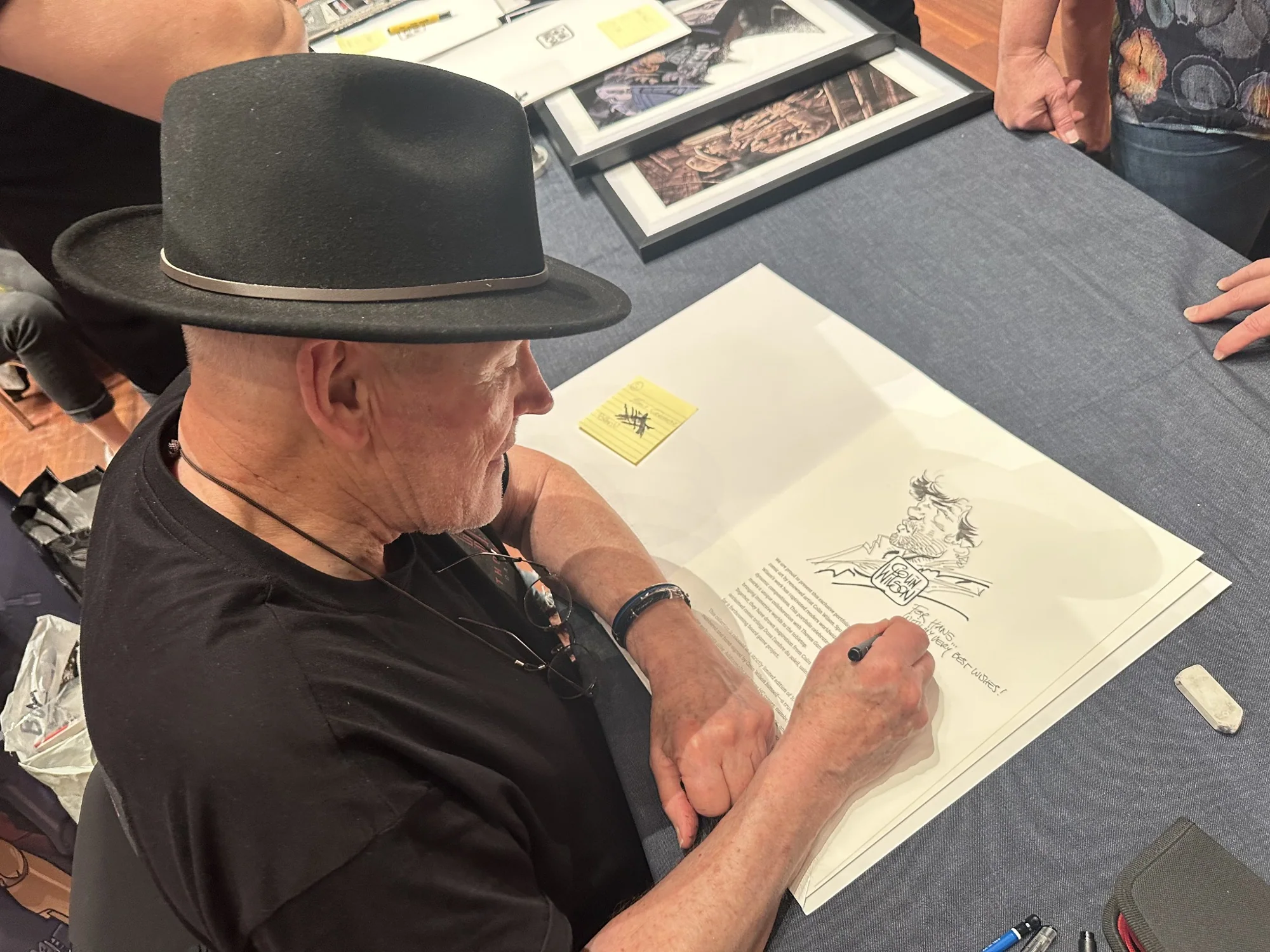 Artist signing artwork